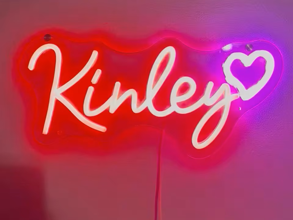 Custom name sign glowing in a styled room